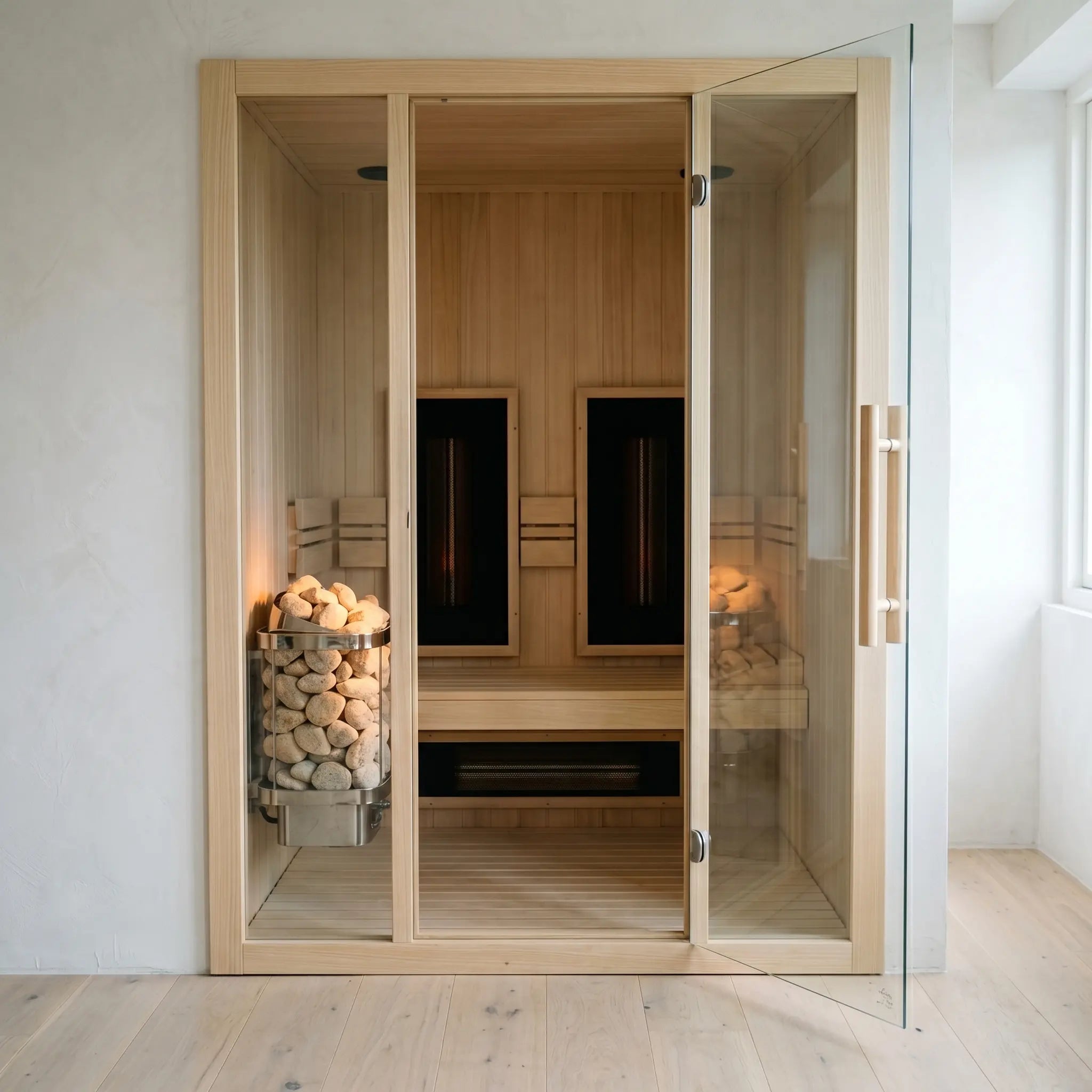 Hybrid saunas interior with a stone heater on the left and infrared carbon panels on the right, seen through the open glass door