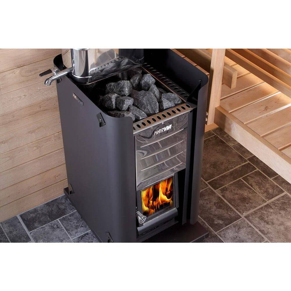 Harvia Pro 36 Wood-Burning Sauna Stove installed in a wood paneled sauna, overhead view showing the chimney pipe and tiled floor.