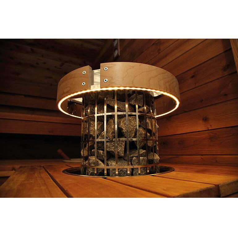 Harvia Cilindro LED Safety Railing for 6 & 8kW Sauna Heaters, close up view of the illuminated ring around a heater in a wood paneled sauna.