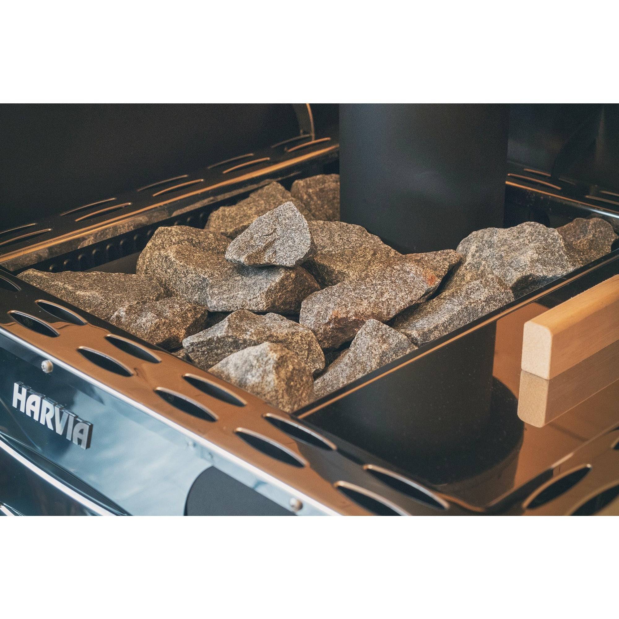 Harvia Pro 20 LS Wood-Burning Sauna Stove with Water Tank, close-up of the stacked sauna rocks and chimney pipe on top of the stove.