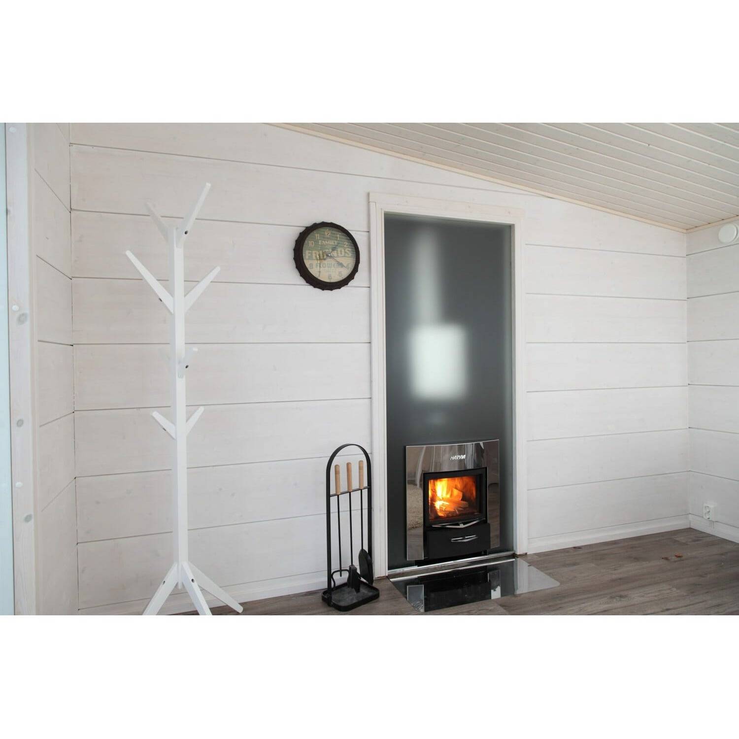 Harvia 20 Duo Wood-Burning Sauna Stove, installed in a wood paneled room with a lit fire visible through the glass door.