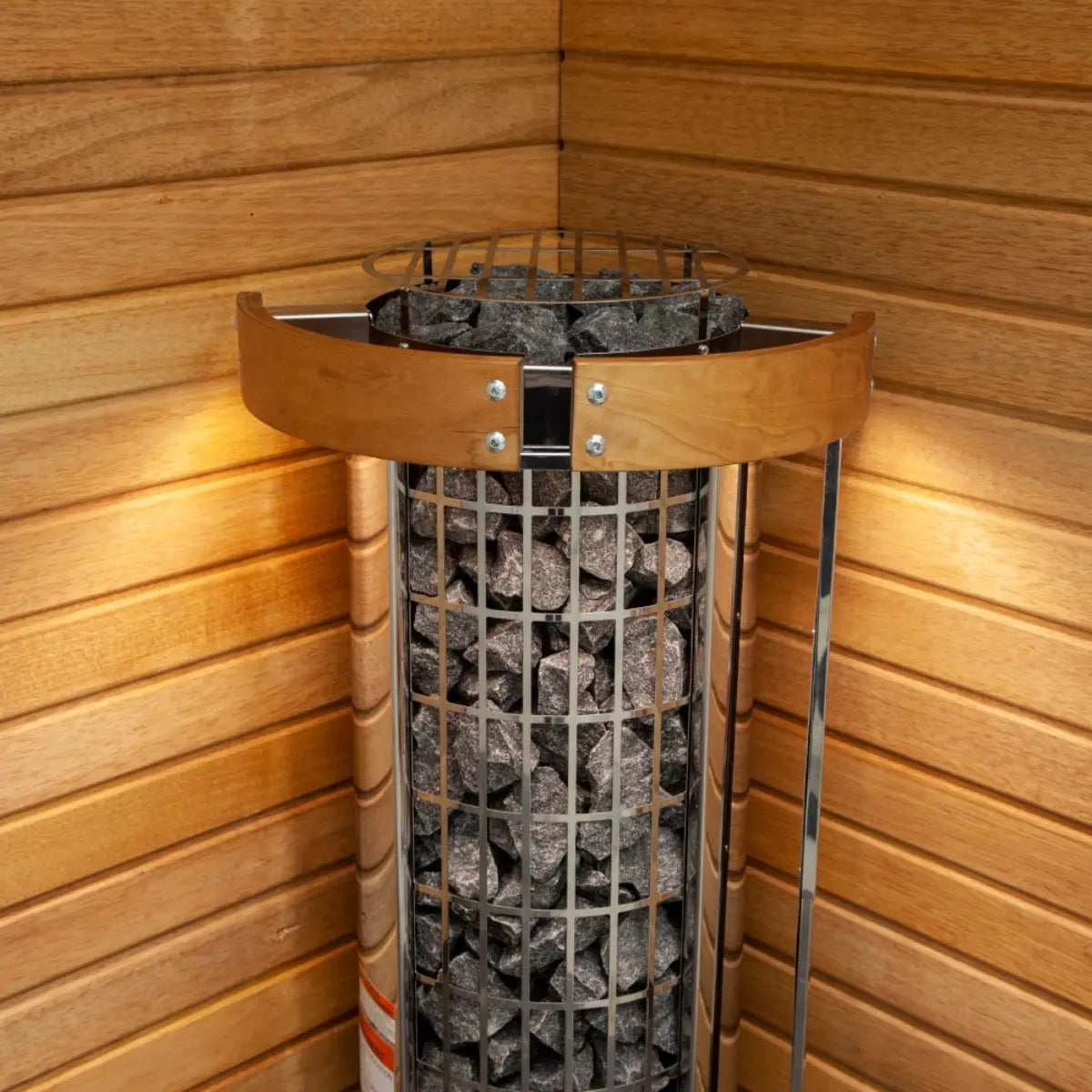 Harvia Cilindro PC110E 10.5kW Electric Sauna Heater, top down close up in a wood corner install showing the stone bed.