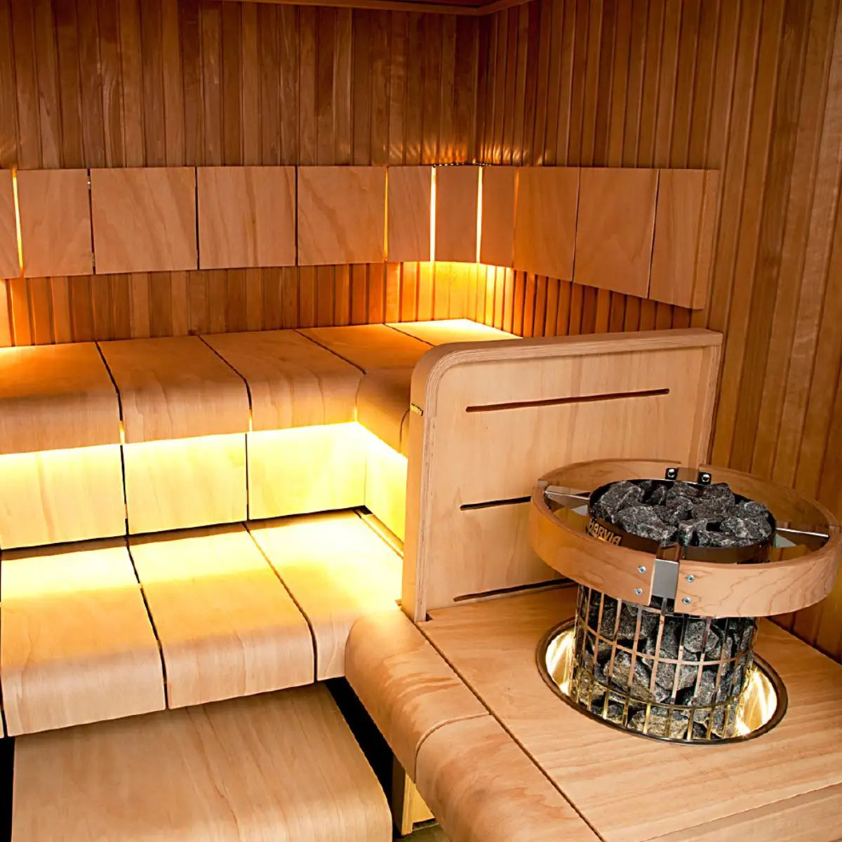 Harvia Cilindro PC60 6kW Electric Sauna Heater with Built-In Controls, in an LED lit sauna corner with a glass safety rail around the stones.