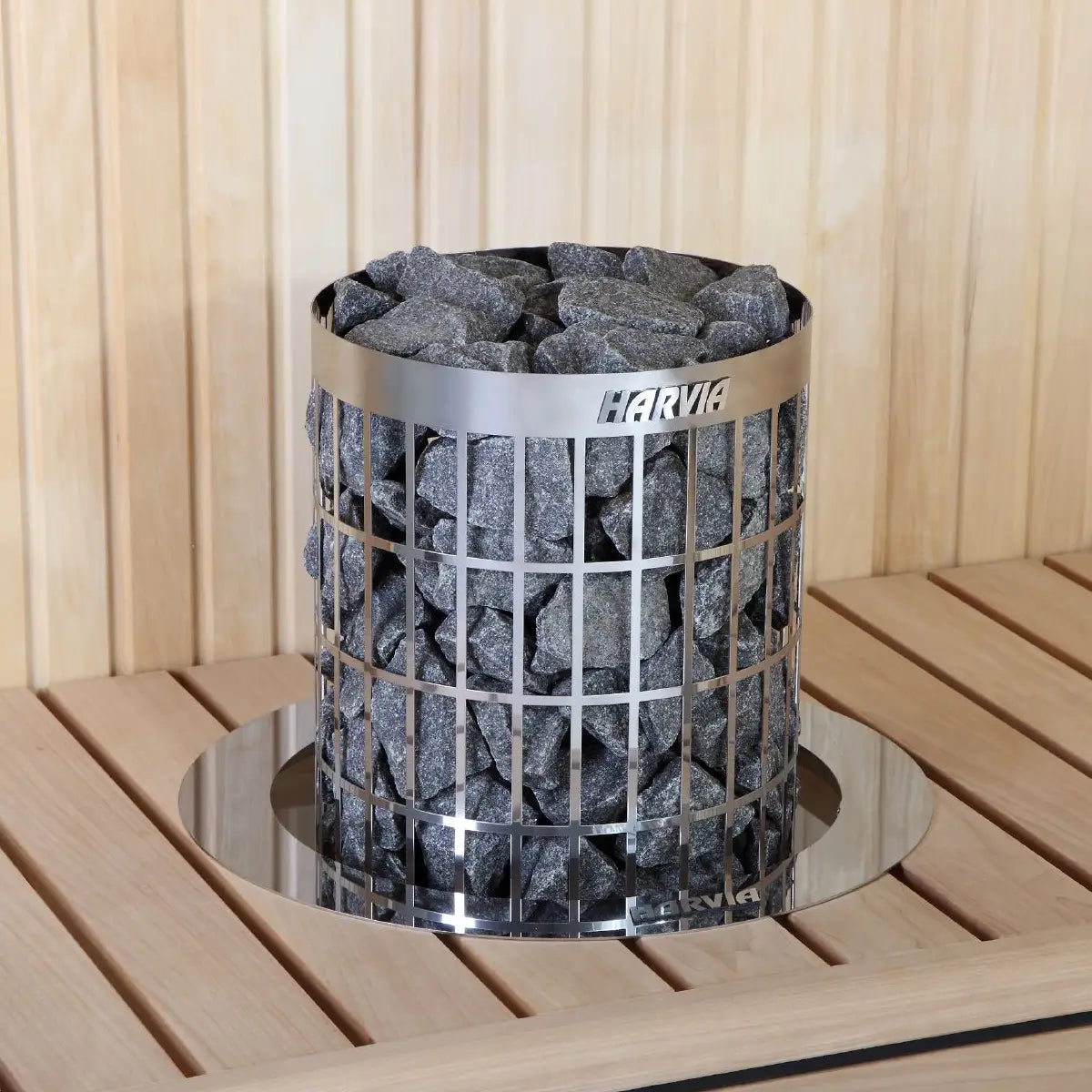 Harvia Cilindro PC90 9kW Electric Sauna Heater with Built-In Controls, full view on a wood slat bench with a round reflective base plate.