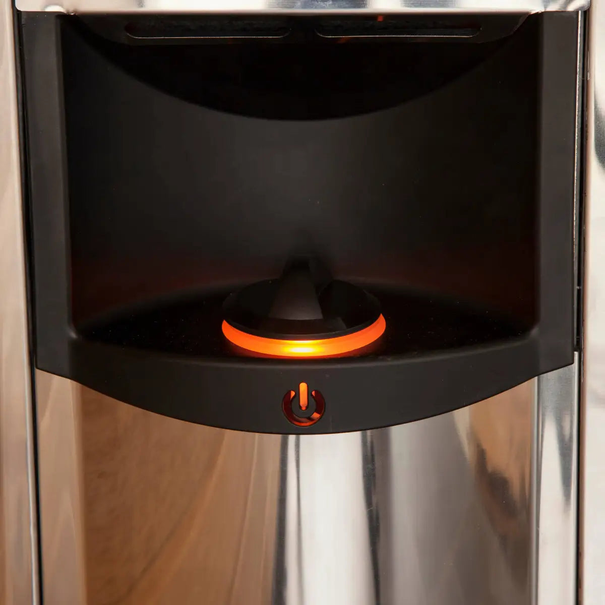 Harvia The Wall SWS60 6kW Electric Sauna Heater with Built-In Controls, close-up of the power button and glowing orange indicator ring