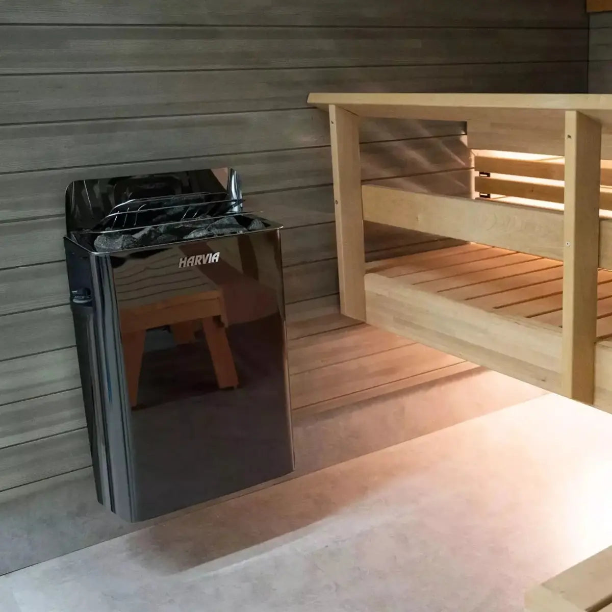 Harvia The Wall SWS60 6kW Electric Sauna Heater with Built-In Controls, black model wall-mounted in a wood-paneled cabin interior