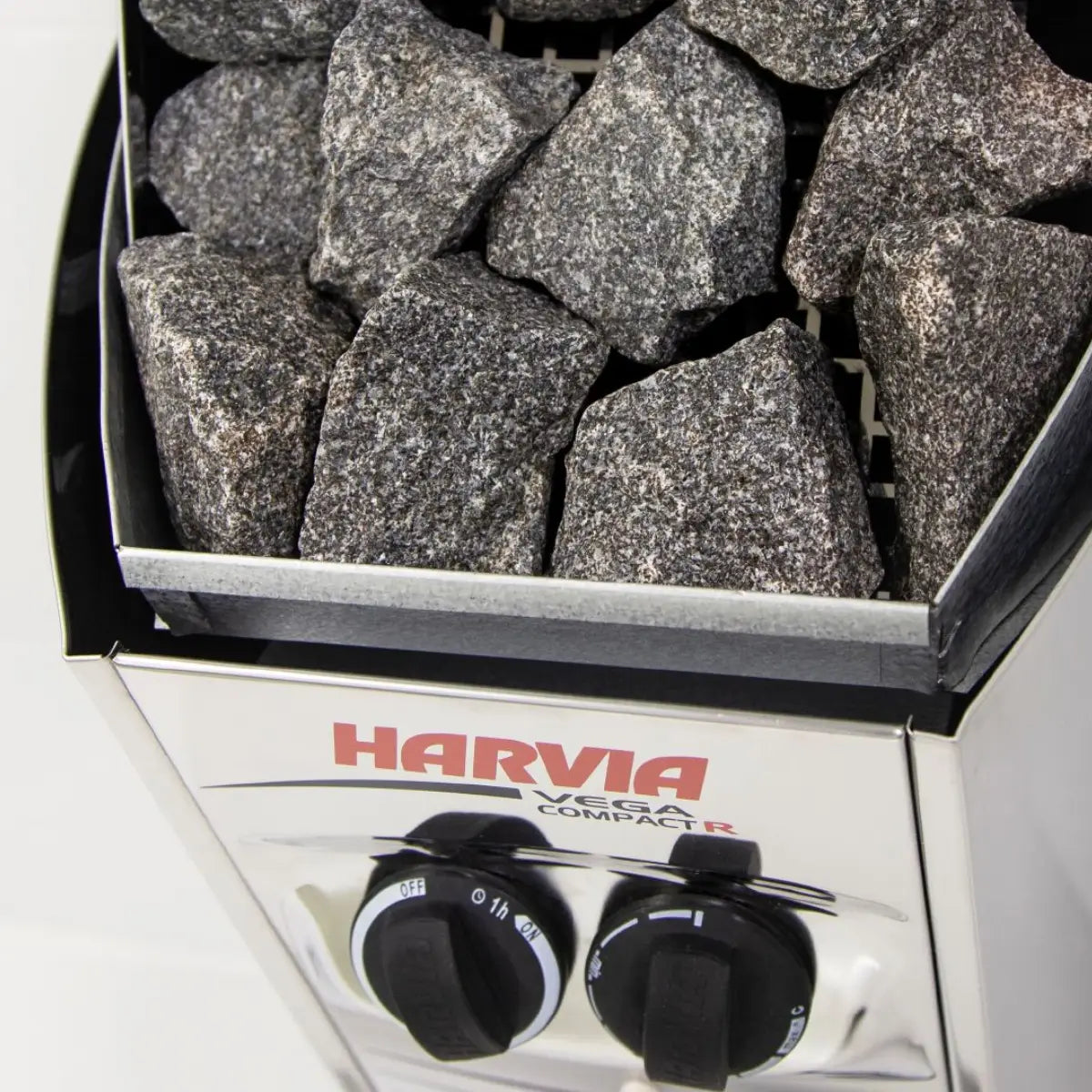 Harvia Vega Compact 1900 1.9kW Electric Sauna Heater with Built-In Controls, close up of stone-filled top and control dials on a white background.