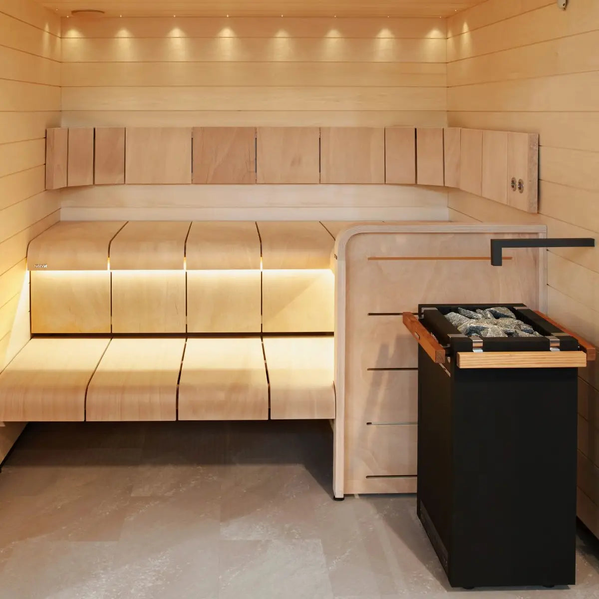 Harvia Virta HL90 9kW Electric Sauna Heater installed in the corner of a wood paneled sauna with bench seating and ambient lighting.