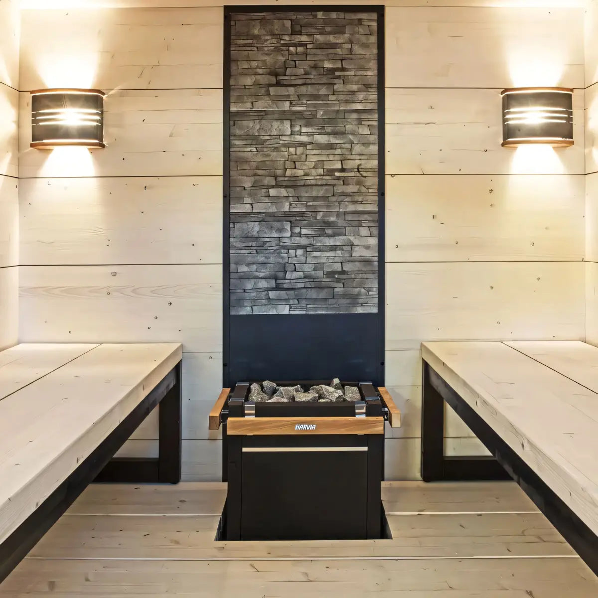 Harvia Virta Pro HL160 16kW Electric Sauna Heater, centered in a light wood sauna between two benches under a stacked stone accent wall