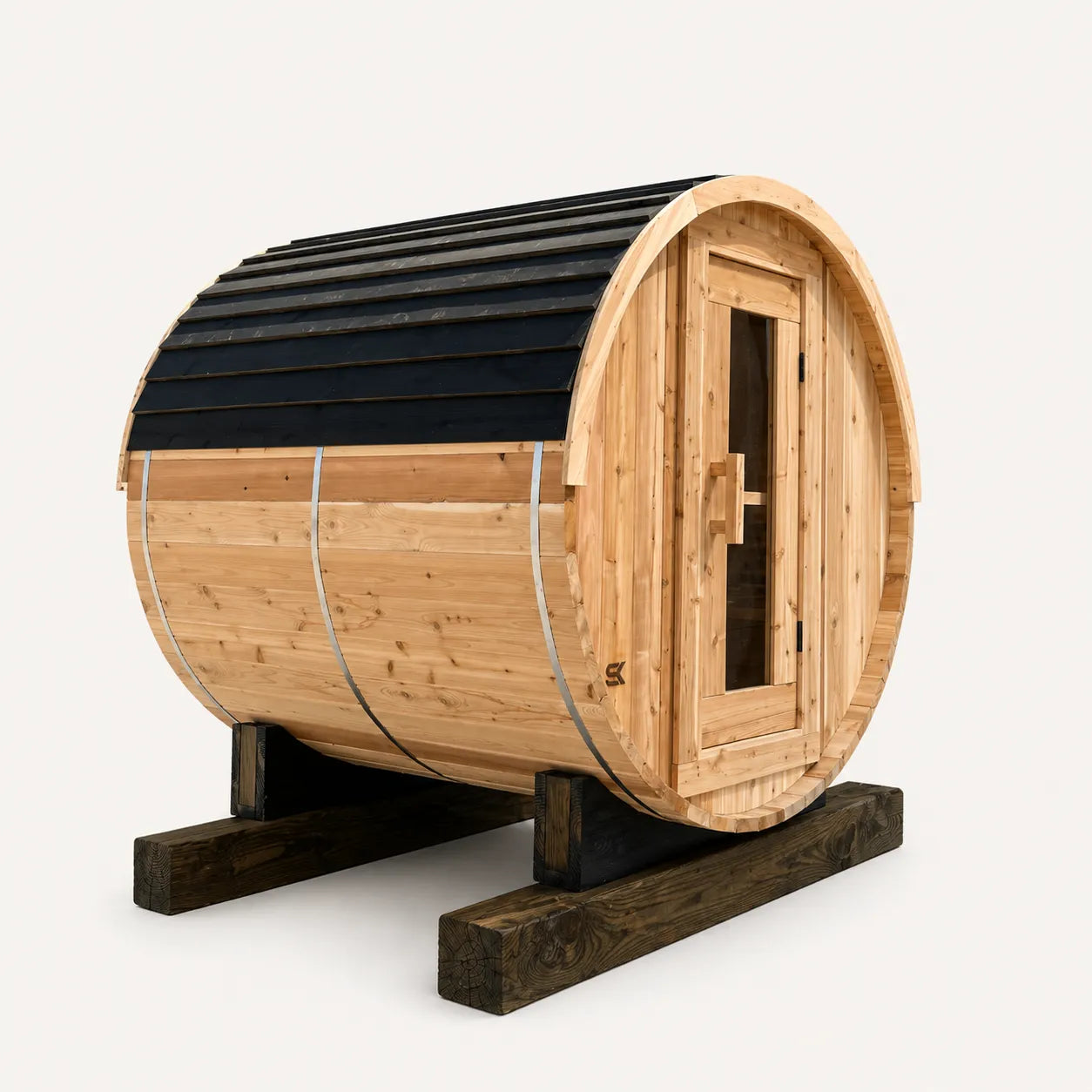 The Sweat Barrel cedar sauna with black asphalt shingle roof on a wooden cradle base, three-quarter angle on white background.