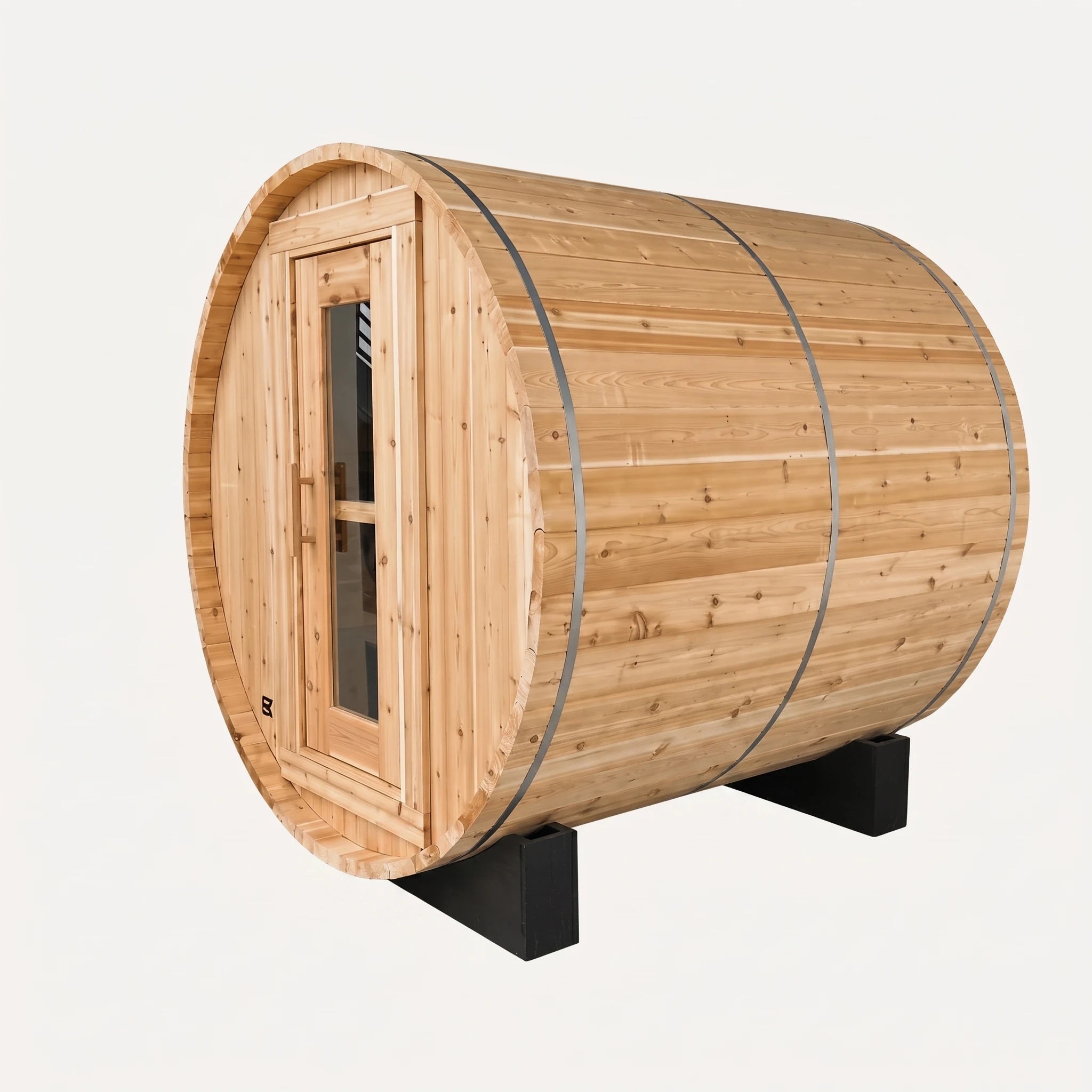 The Sweat Barrel cedar barrel sauna on white background showing three-quarter angle, glass door with window panel, and black metal cradle base.