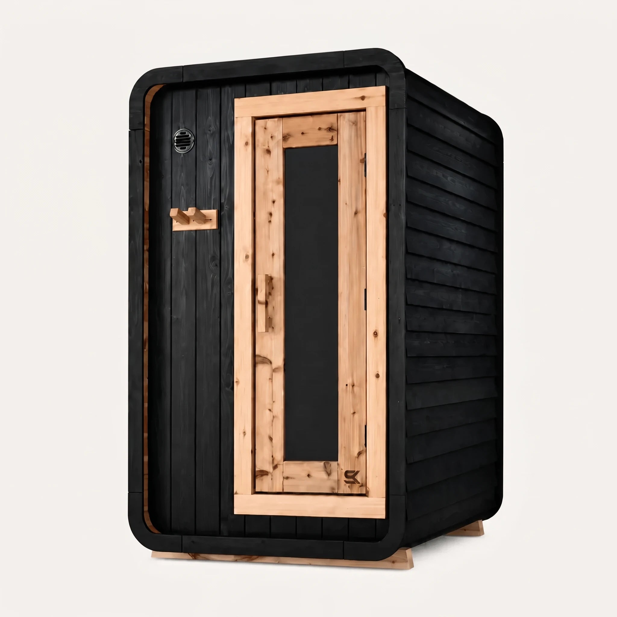 The Sweat Pod Black Edition Shou Sugi Ban charred cedar sauna on white background, three-quarter angle with natural cedar door frame.