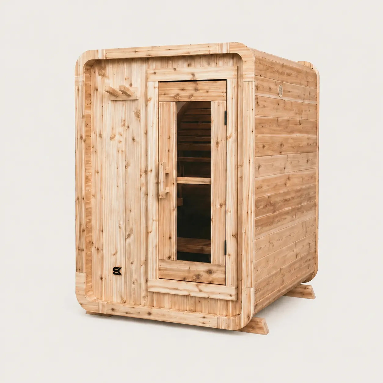 The Sweat Pod cedar indoor sauna front-angled view on white background showing depth, glass door, and interior cedar bench.