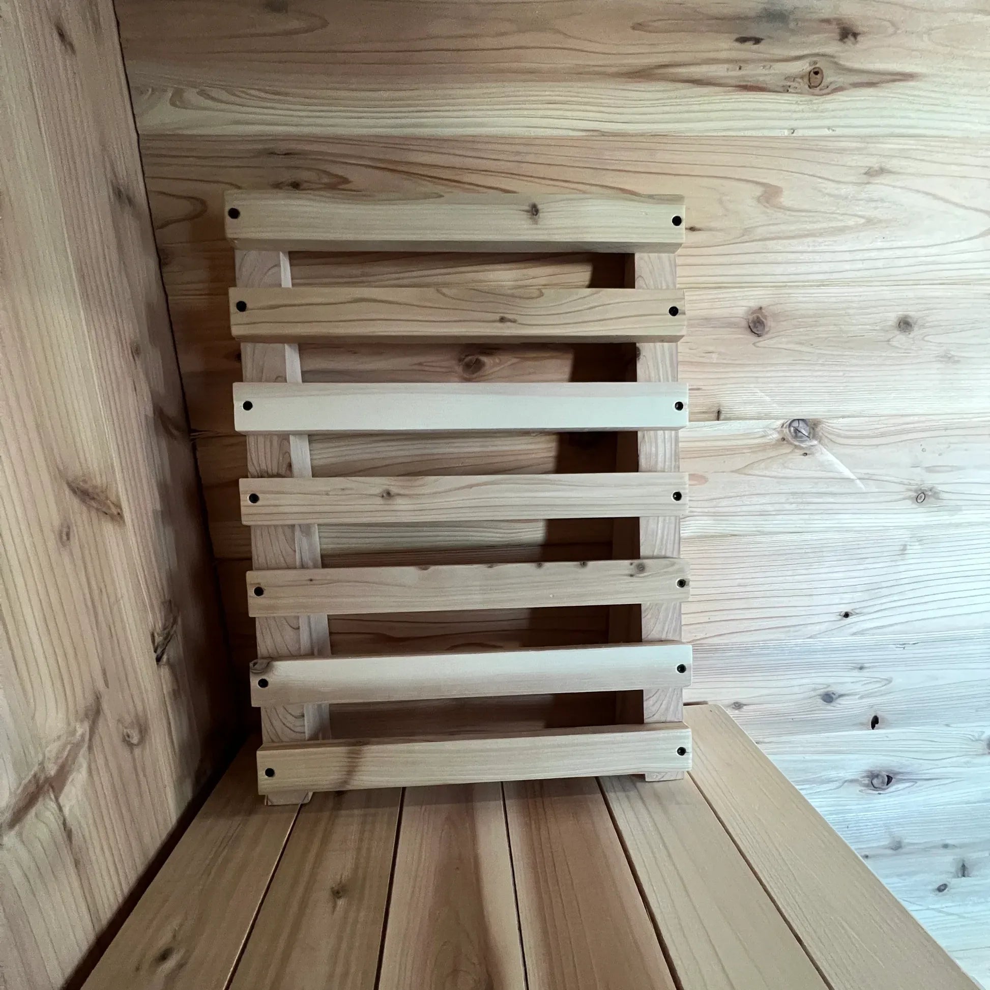 Front view of cedar sauna backrest with smooth open slats for comfortable back support
