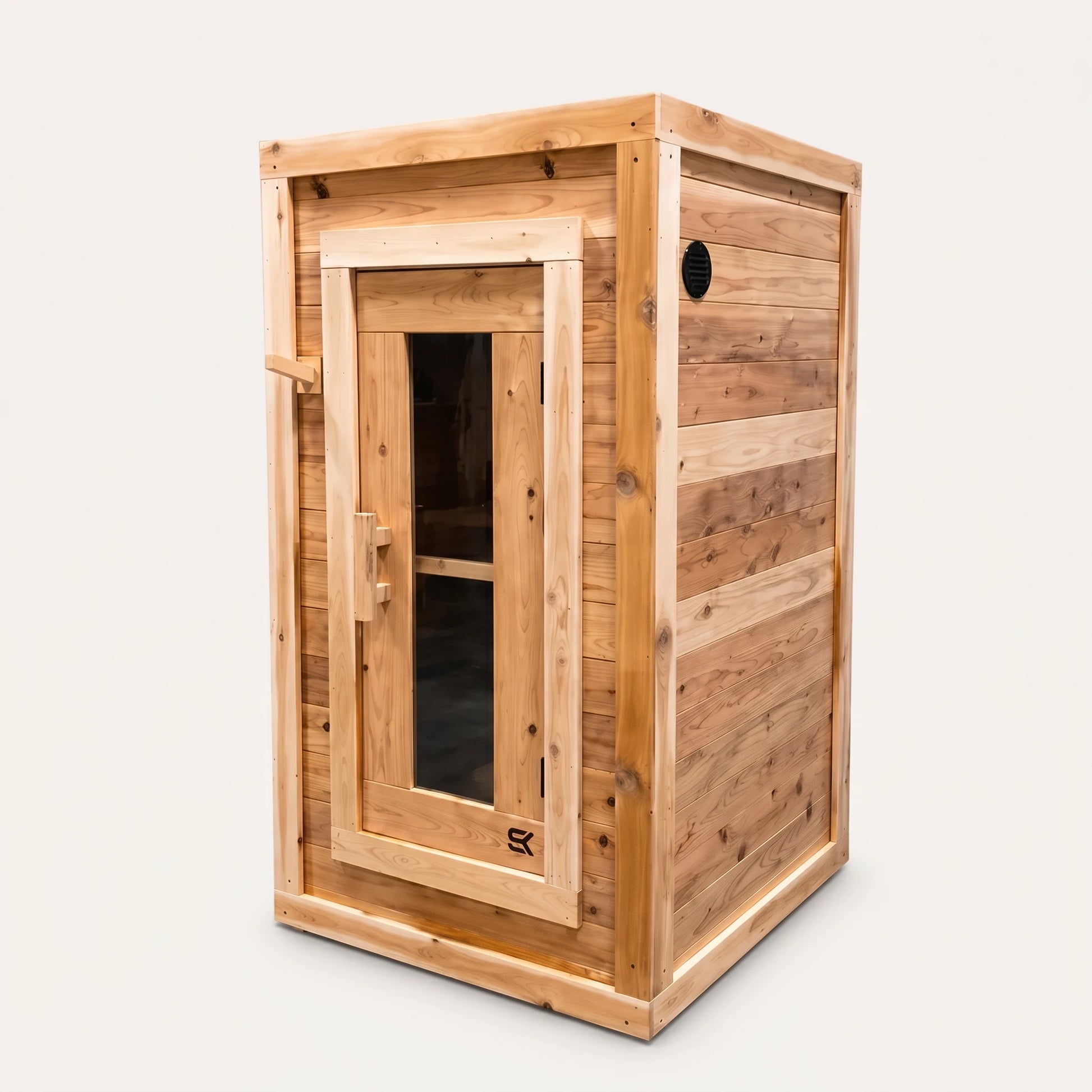 The Sweat Box red cedar sauna on white background showing front door, side vent, and compact 42-inch depth.
