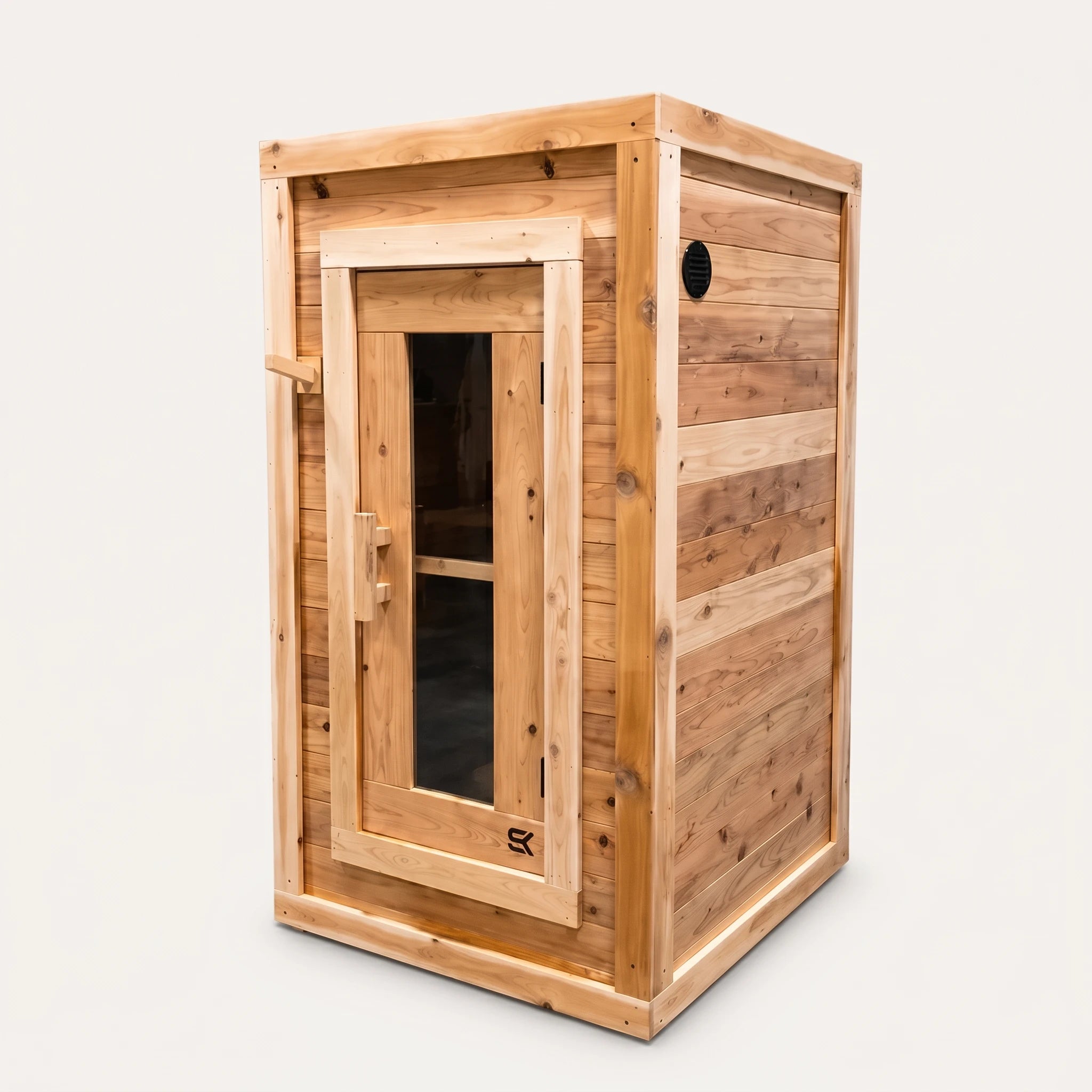 The Sweat Box red cedar sauna on white background showing front door, side vent, and compact 42-inch depth.