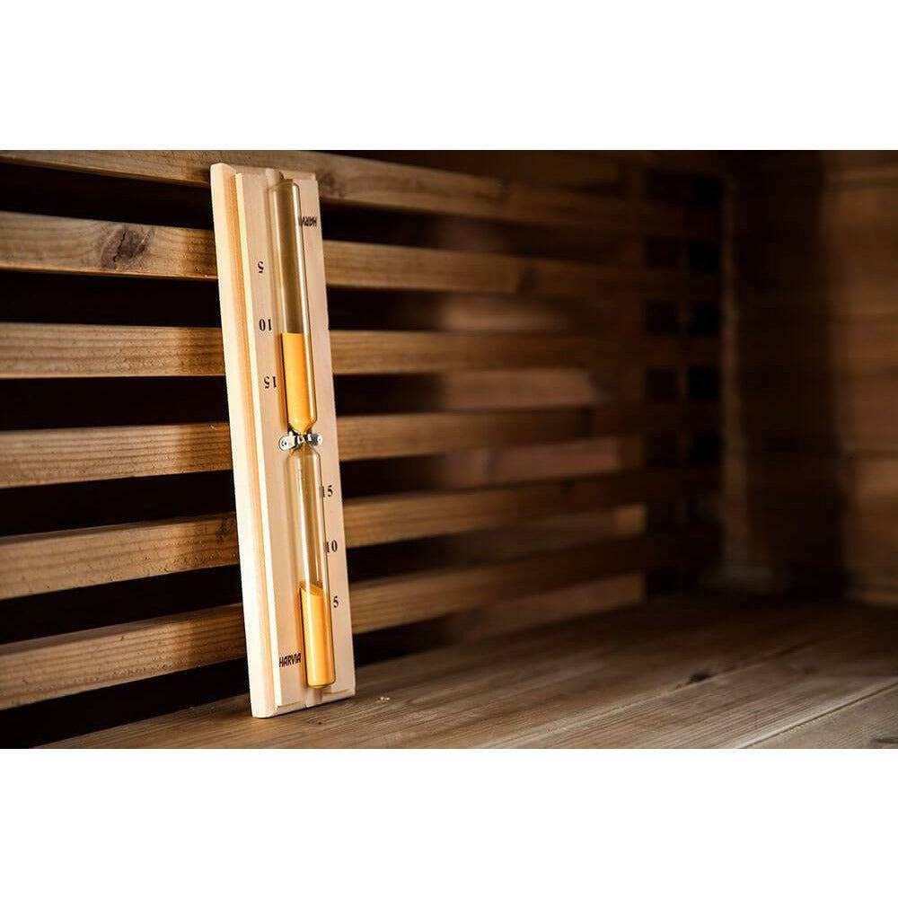 Harvia Sauna Sandglass Timer with wooden frame and minute markings leaning against slatted wood sauna benches