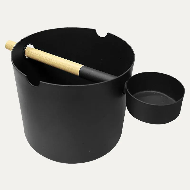 Close side view of the KOLO black aluminium sauna bucket and matching ladle, highlighting the rounded form, bamboo grip and compact scoop.