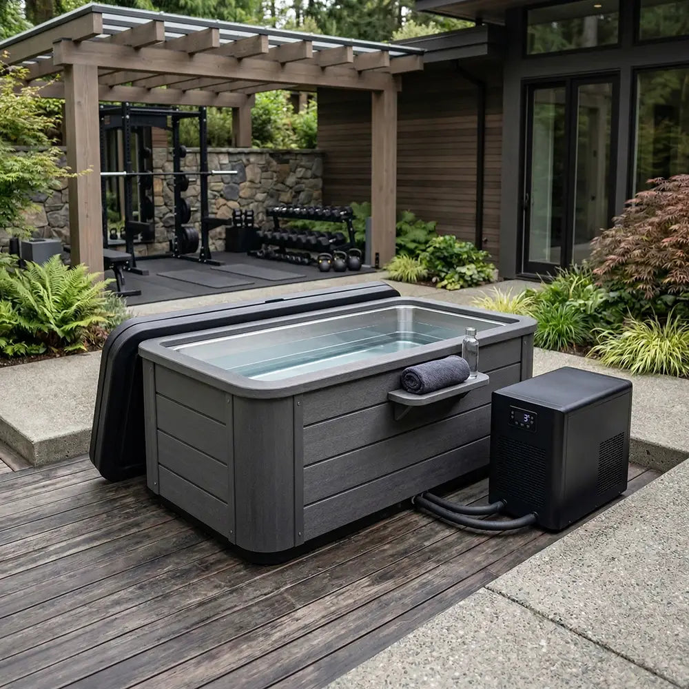 Outdoor cold plunge tub with chiller on a backyard deck beside a covered patio gym area.