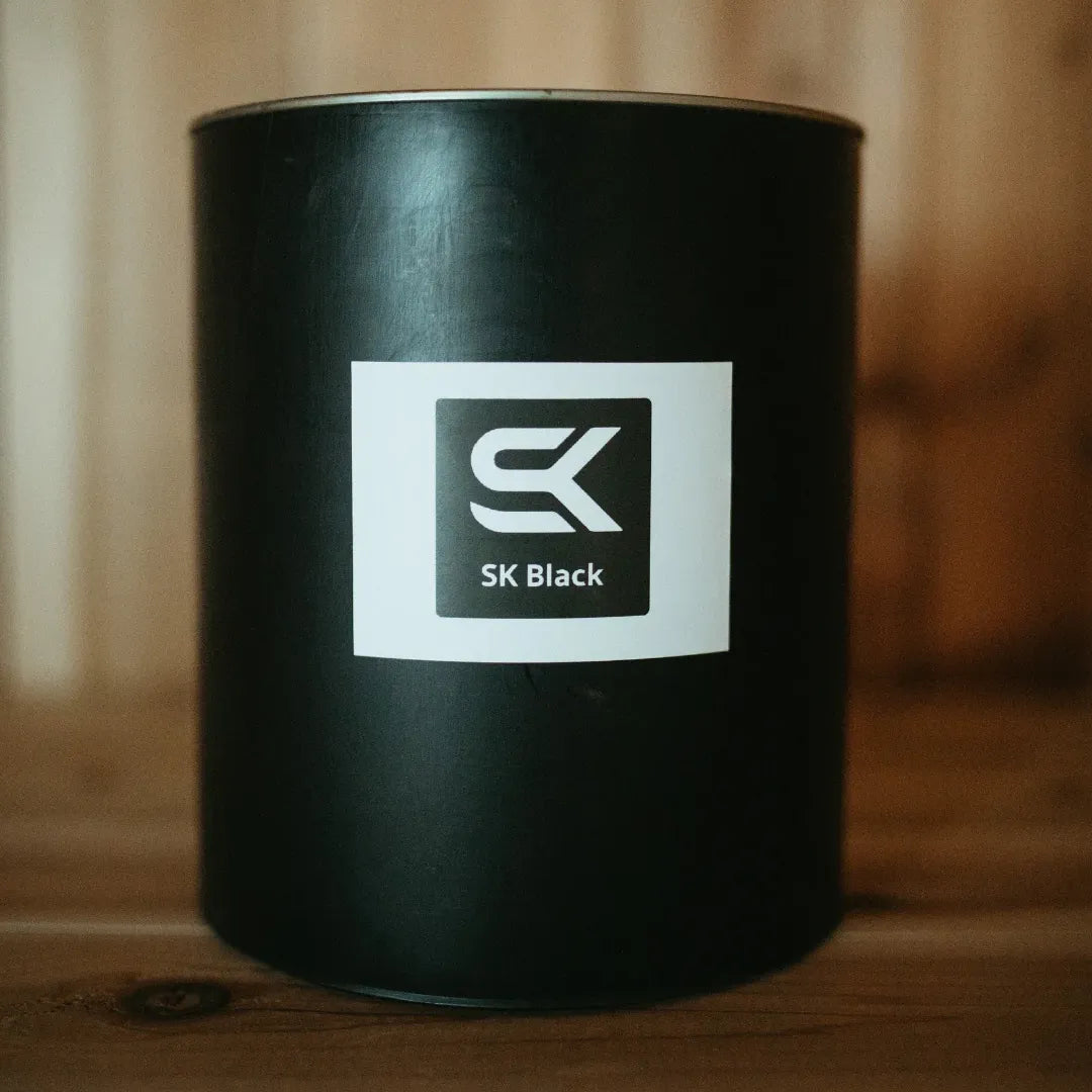 Close-up of SK Sauna Stain SK Black gallon can for outdoor sauna wood finishing