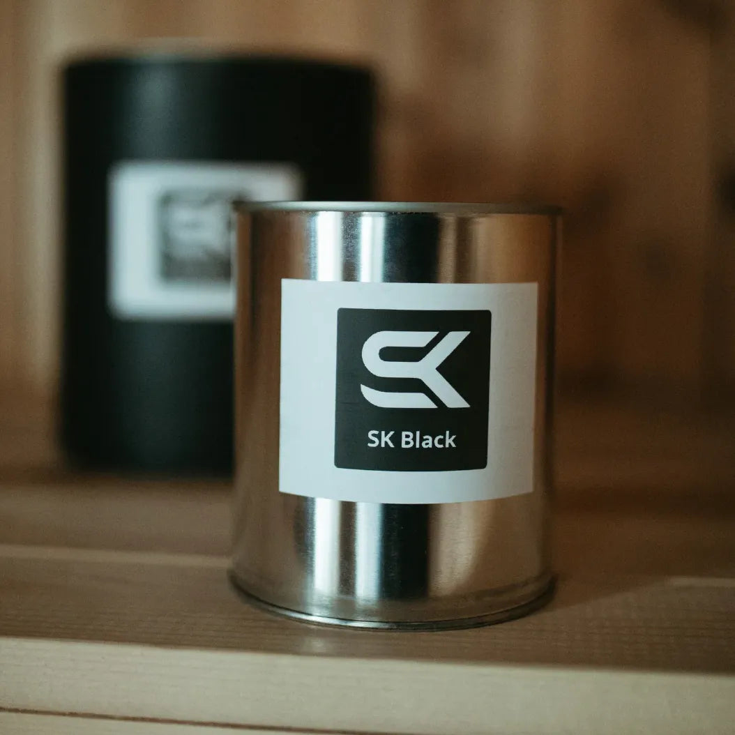 SK Sauna Stain SK Black quart can displayed inside a wood sauna interior