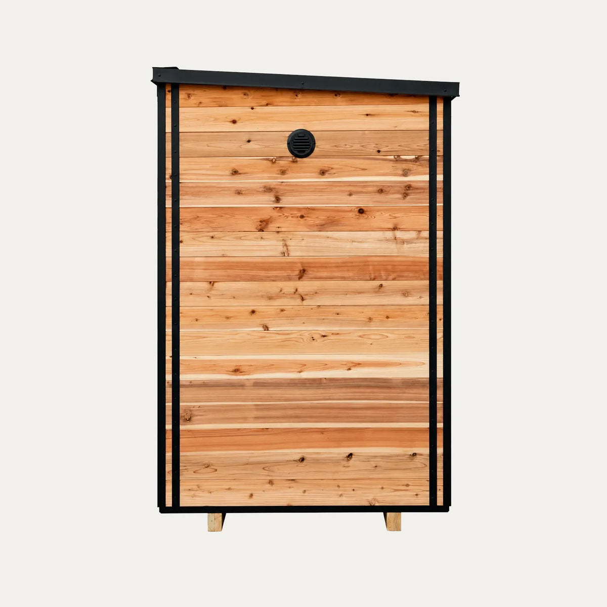 Side view of the Sweat Kingdom Ridge sauna showing wood siding, black trim, and an upper wall vent.
