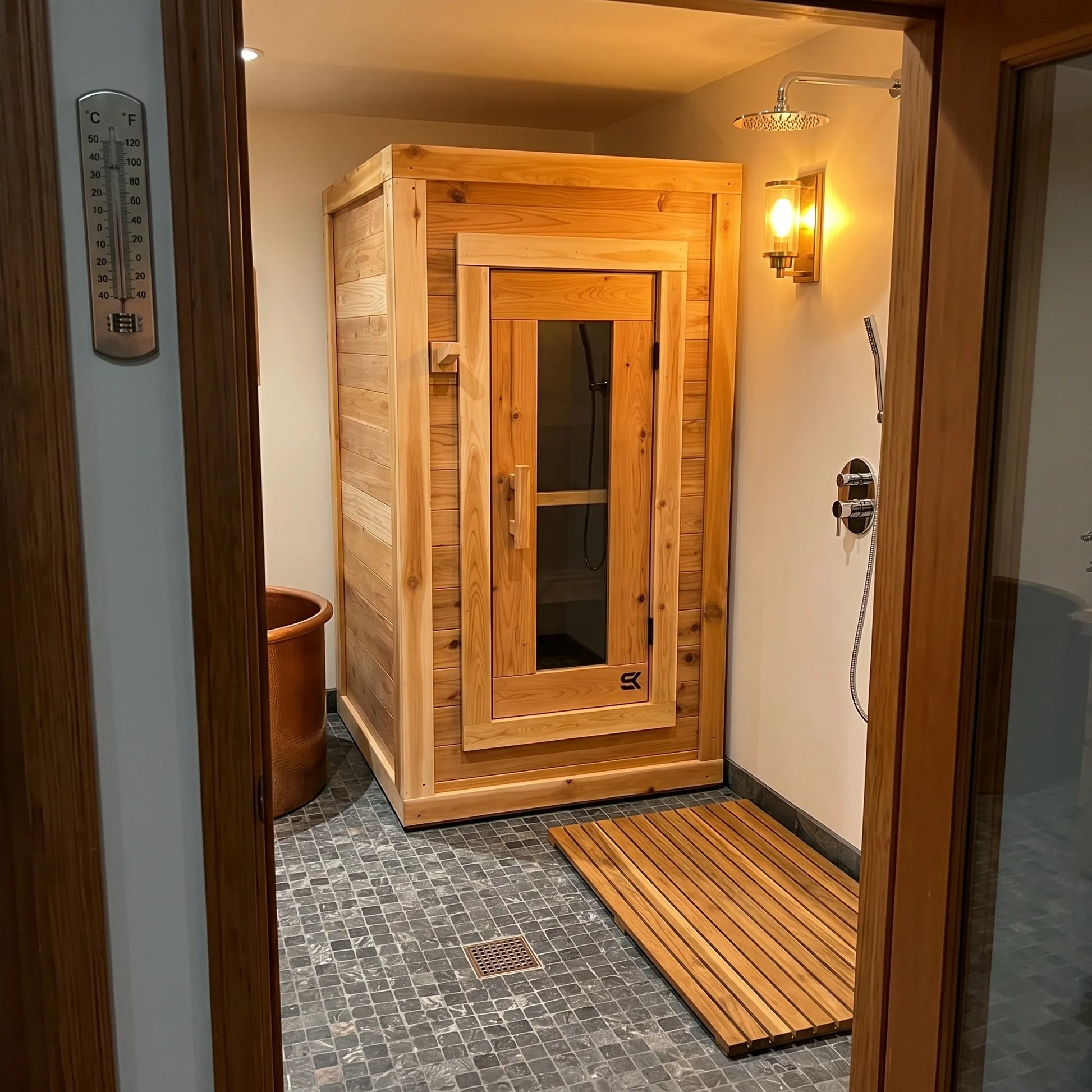 The Sweat Box red cedar sauna inside a wet room with shower fixtures and cedar floor mat.